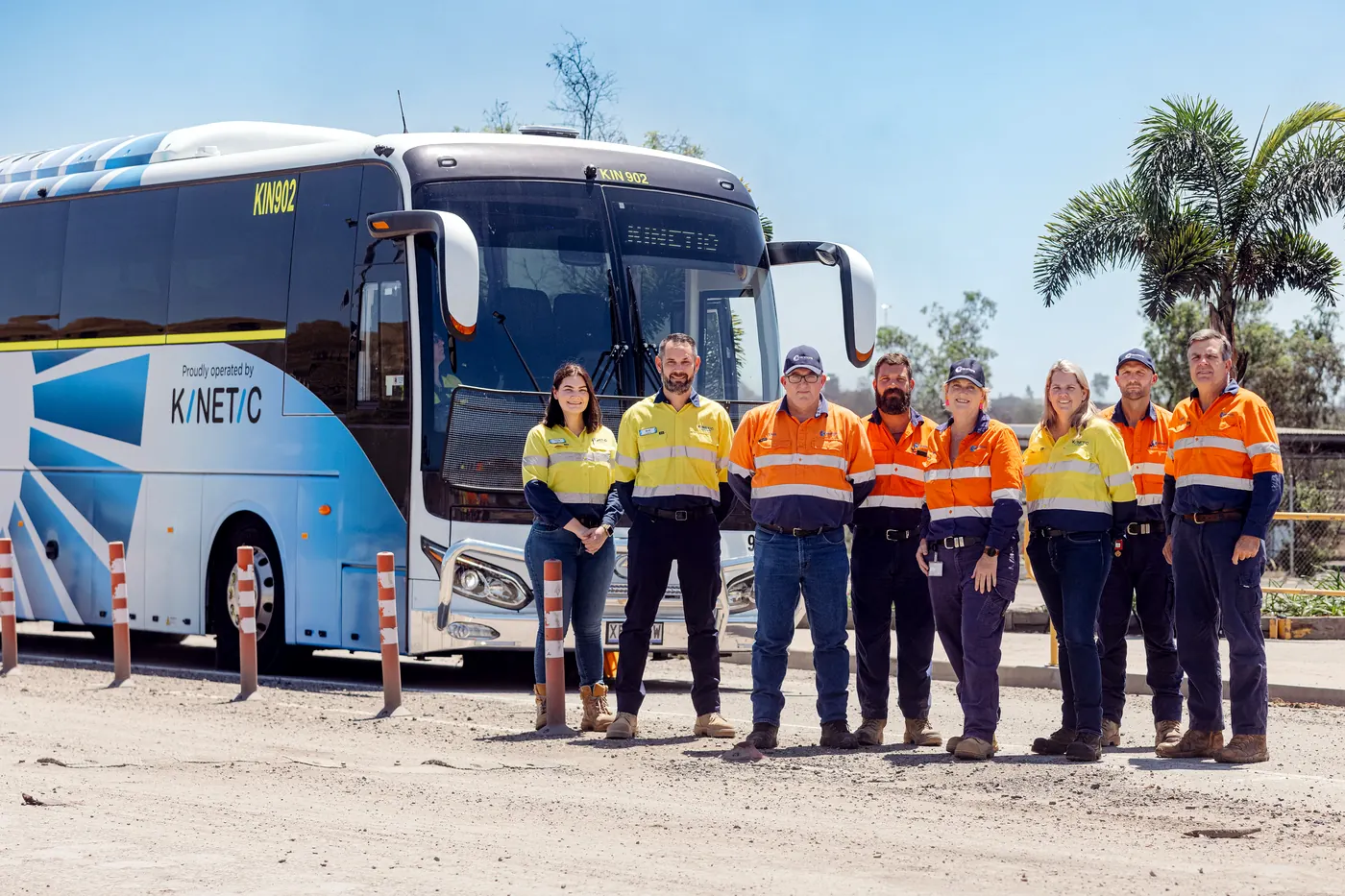 Mine site crew in hi-vis with a King Long EVolution electric coach operated by Kinetic