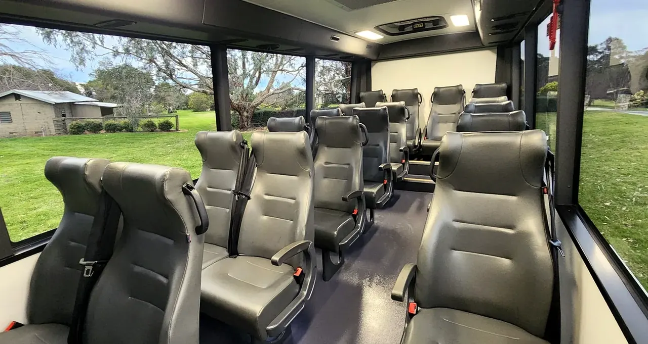 I-Bus NPS 19-Seat 4×4 interior — grey mine-spec seating with 3-point belts
