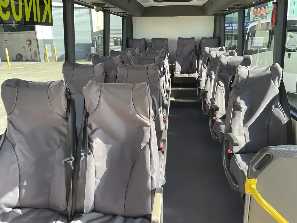 Crew coach interior — high-back seating, belts on every seat